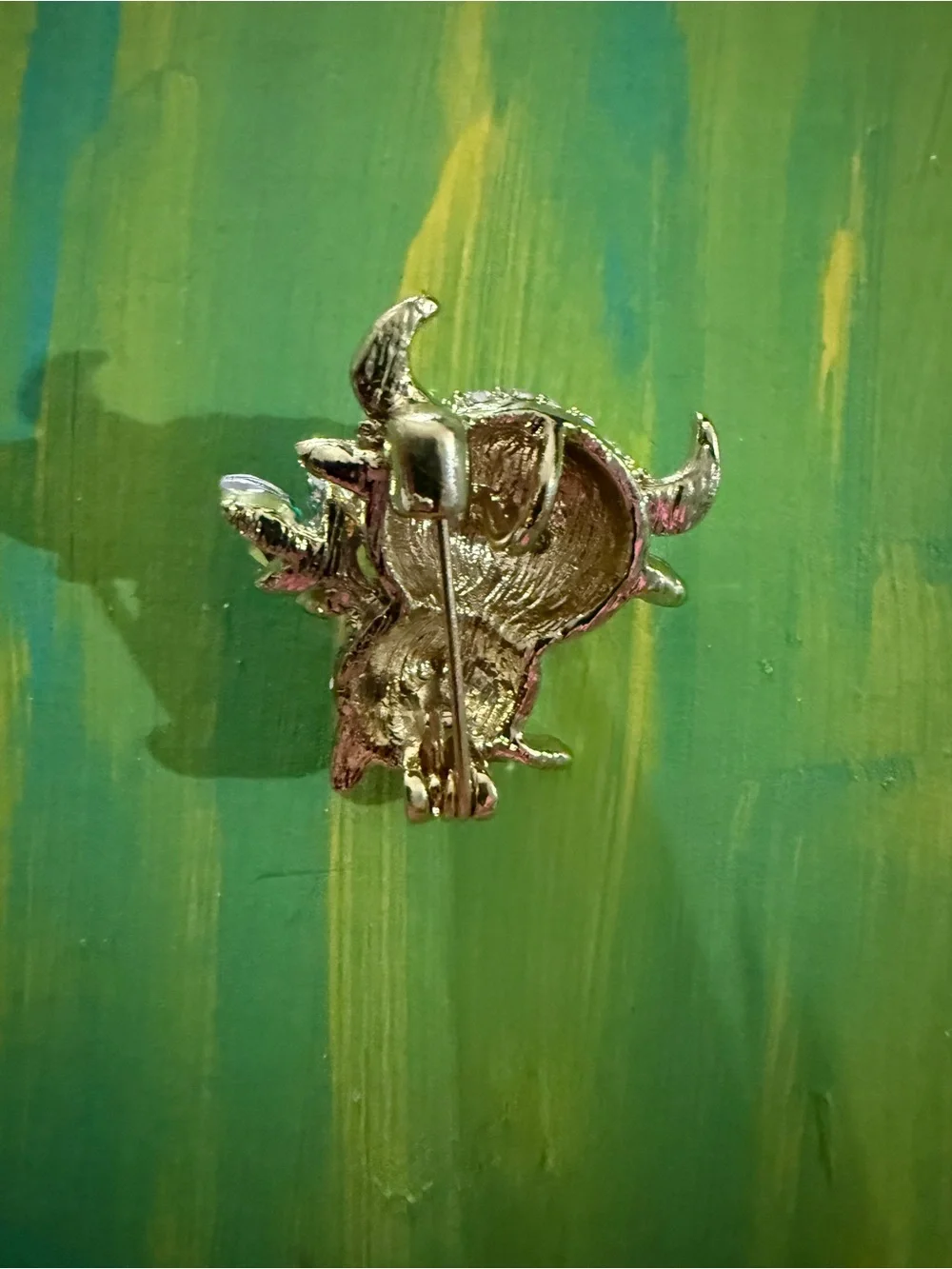 Crystal Buffalo Brooch with Green Leaf Accent